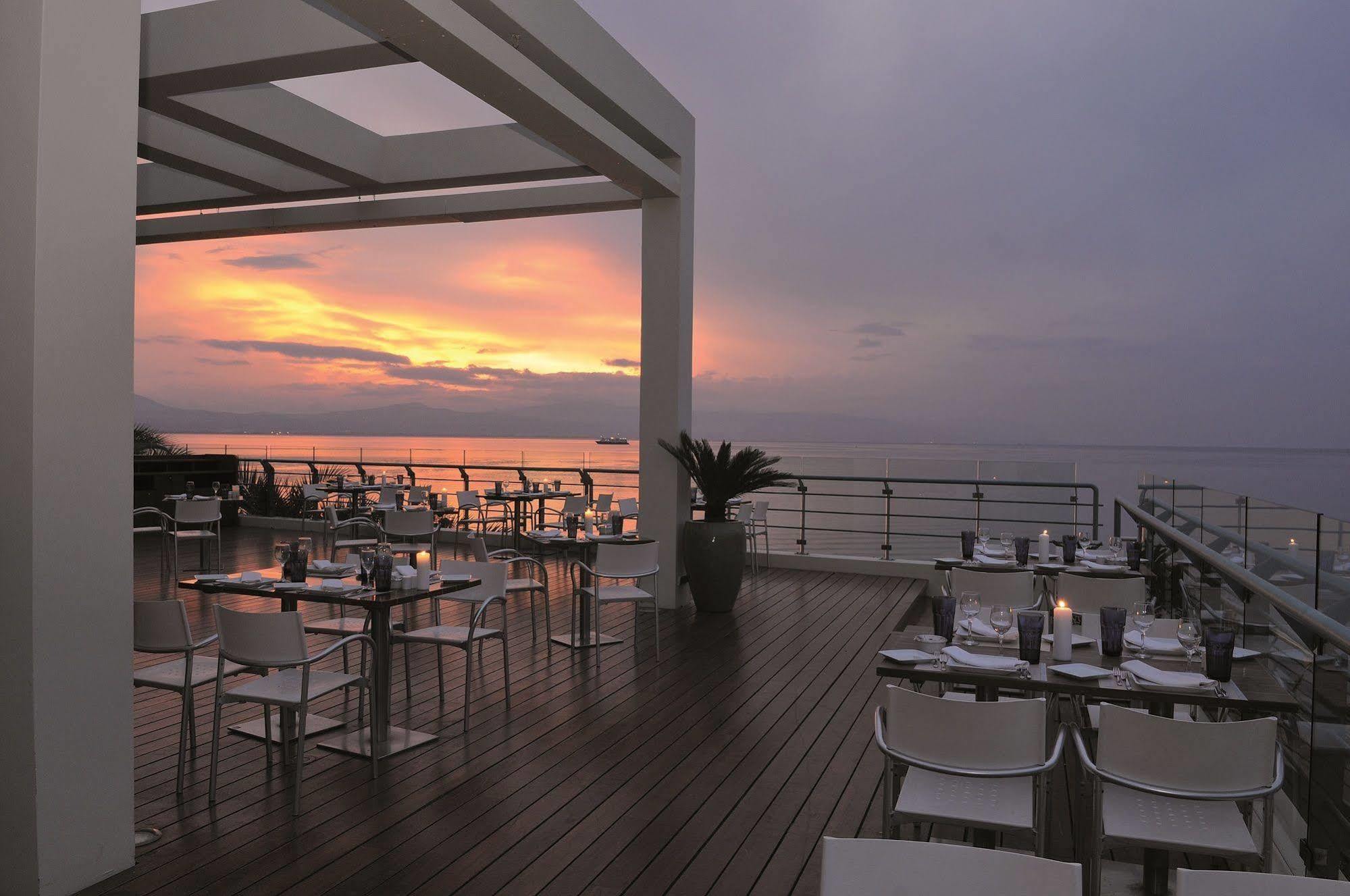 Club Hotel Casino Loutraki Exterior photo Sunset at the Sky Bar